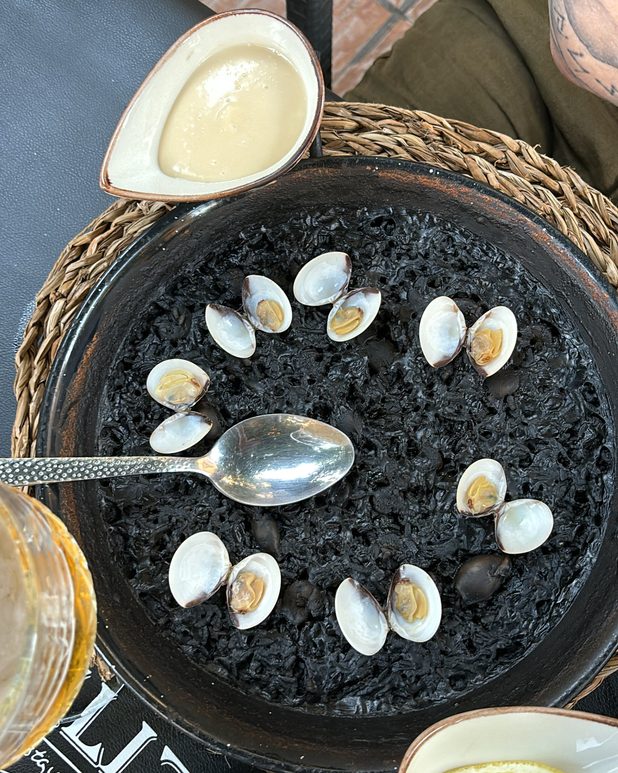 Arroz negro ringed with clams, aioli on the side