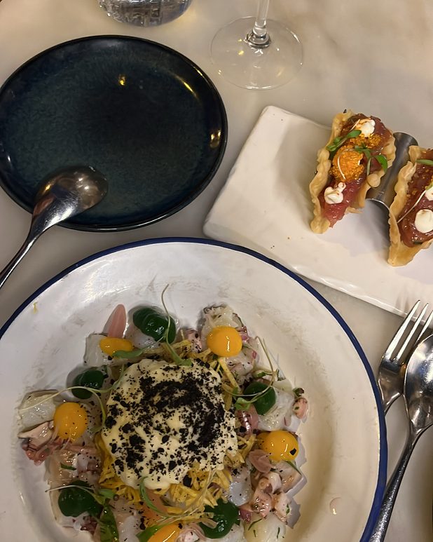 Ceviche with citrus and a black olive crumb