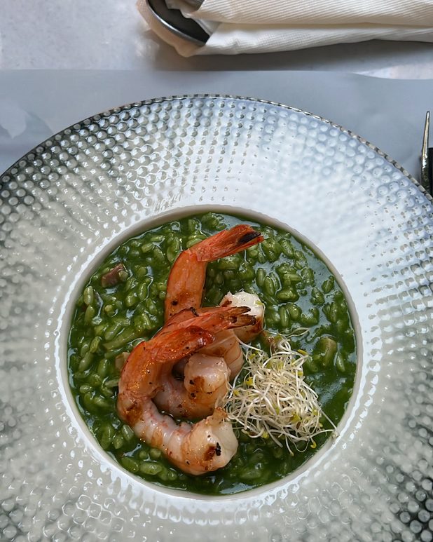 Bright green pea risotto with grilled prawns