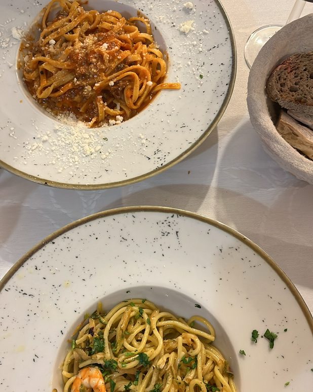 Two pasta plates — a ragù and a prawn spaghetti