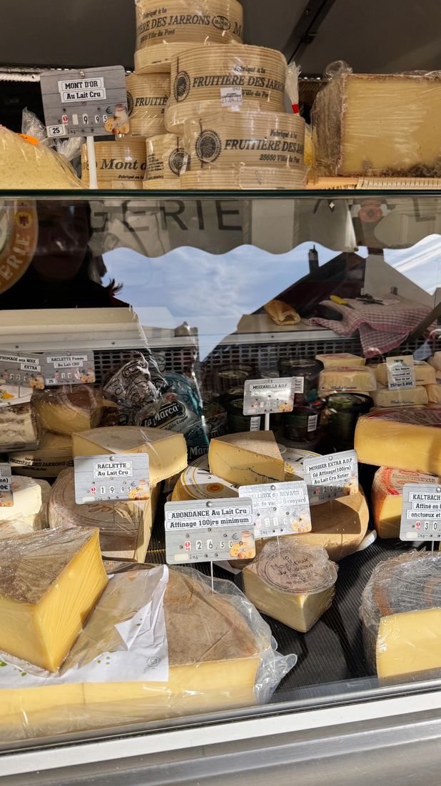 A fromagerie counter, cheeses labeled and ready to taste